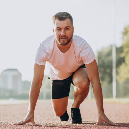 Man athlete jogging at stadium in the morning